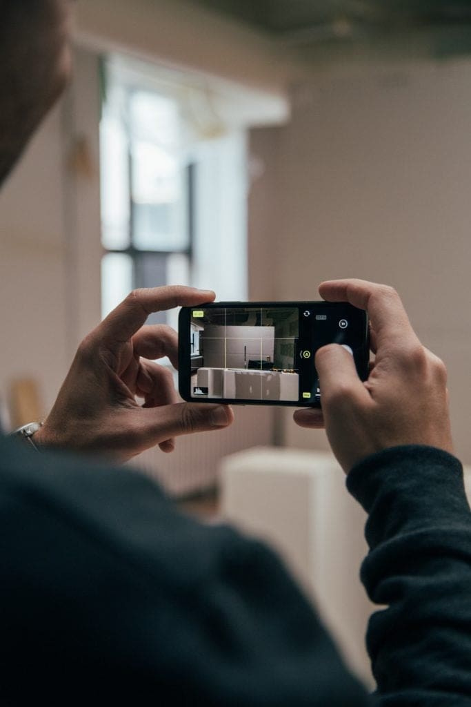 Young man preparing logistics organisation, taking a photo of a kitchen renovation 