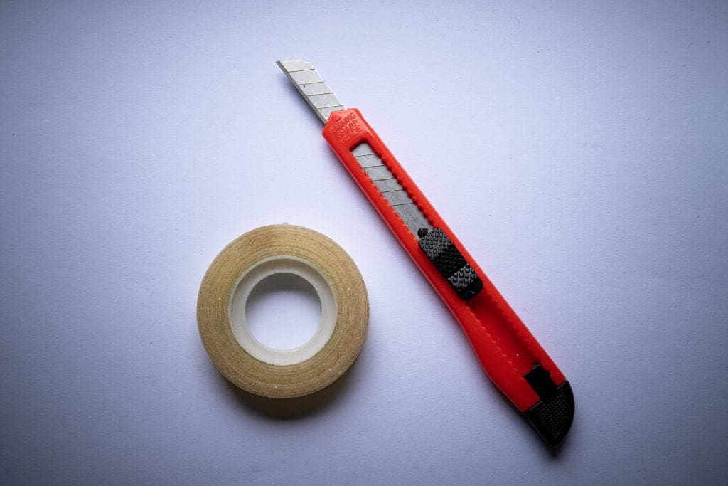 Boxcutter and masking tape, trusty companions on moving day