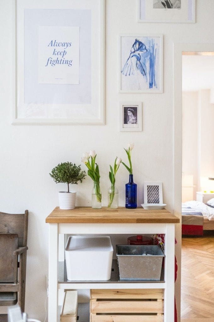 Kitchen island and gallery wall in a styled rental home